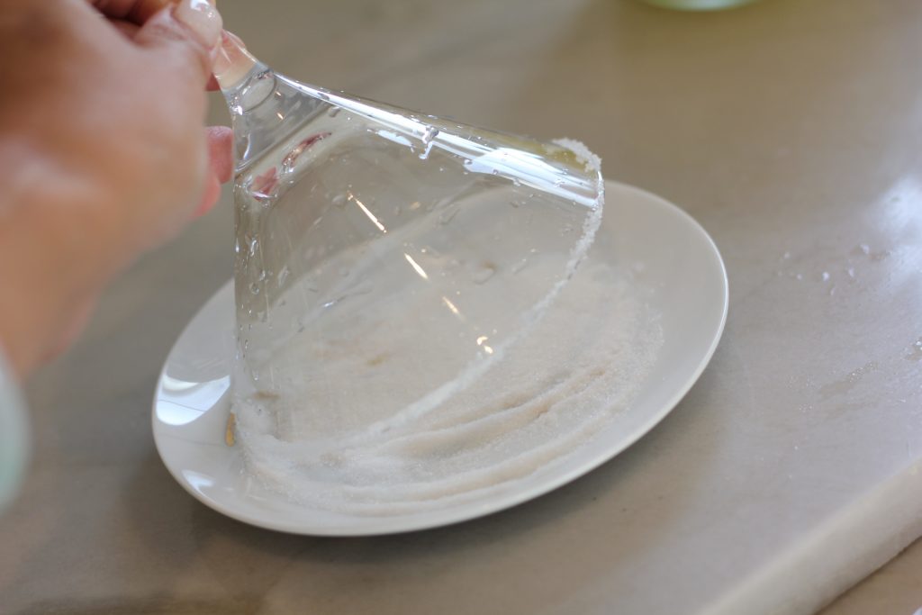 Wet the rim and dip the glass upside down to coat with sugar.