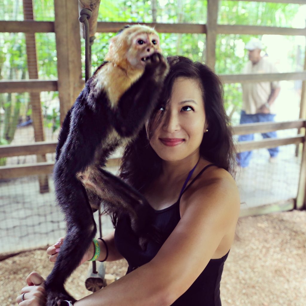 woman holding a monkey in Roatan 