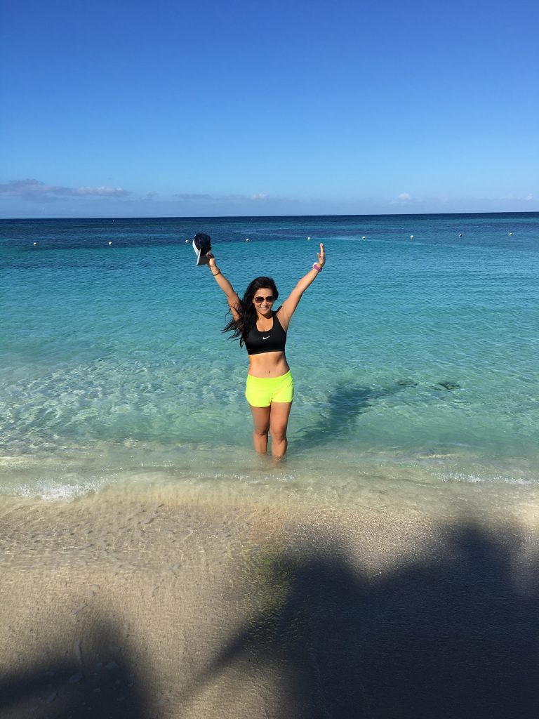 Woman standing in the surf on the beach in Roatan