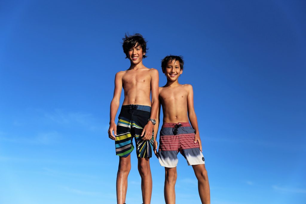 two boys smiling into the camera in Roatan