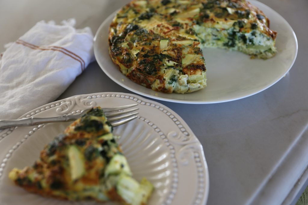 Whole30 Spinach Onion Zucchini Frittata served on a white plate