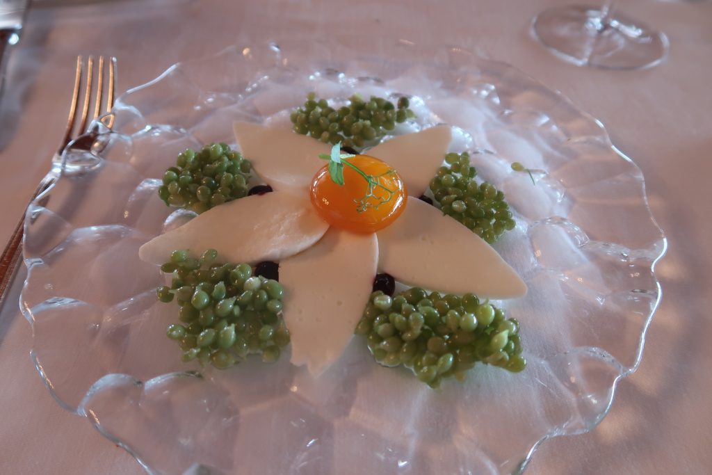 Akelare restaurant dining experience Green Peas with flower with marinated egg yolk.