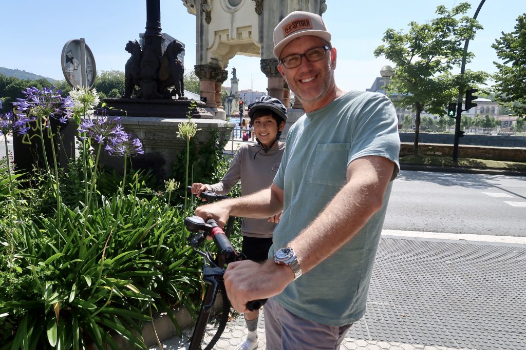 dad and son on electric scooters san sebastian